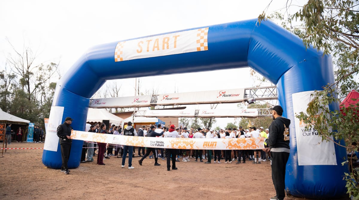 Runners setting off under the start arch in Bouskoura Forest